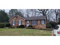Charming brick home with well-maintained lawn and classic architectural details at 425 Whitethorn Dr, Gastonia, NC 28054