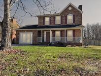 Charming two-story brick home featuring a welcoming front porch and well-maintained lawn at 4405 Ashton Ct, Indian Trail, NC 28079