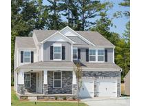 Beautiful two-story home with stone accents, a covered porch, and a two-car garage at 50 Sherwood Nw Ct # Sw50, Concord, NC 28027