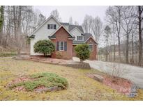 Charming two-story home with a brick facade, white siding, and landscaped front yard at 5306 Club View Dr, Concord, NC 28025