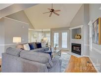 Cozy living room with vaulted ceiling, fireplace, and comfortable seating area at 5306 Club View Dr, Concord, NC 28025