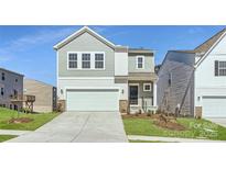 Charming two-story home with a two-car garage and well-maintained lawn at 10115 Chatham Run Ln, Charlotte, NC 28262