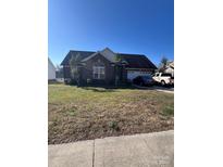 Charming brick home with a well-maintained lawn and inviting curb appeal in a desirable neighborhood at 1232 Pressley Downs Se Dr, Concord, NC 28025