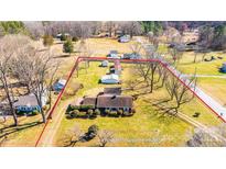 Aerial view of a charming property with a spacious yard, multiple outbuildings, and mature trees at 2375 E Nc 10 Hwy None, Conover, NC 28613