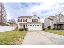 Charming two-story home with a well-maintained lawn and a two-car garage and red shutters at 4213 Devonbridge Ln, Charlotte, NC 28269