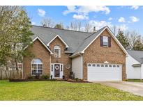 Charming brick home with a well-manicured lawn and a two-car garage in a desirable neighborhood at 4741 Lauren Glen Nw St, Concord, NC 28027