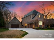 Stunning brick home featuring an attached three car garage and a circular driveway at 5824 Preston Ln, Charlotte, NC 28270