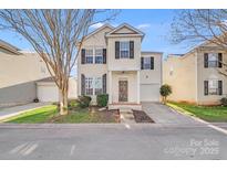 Charming two-story home with well-maintained landscaping and a welcoming front entrance and single-car garage at 7712 Grapetree Ct, Charlotte, NC 28215