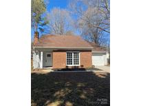 Charming brick home featuring a manicured front yard and attached one car garage at 8515 Mission Hills Rd, Charlotte, NC 28227