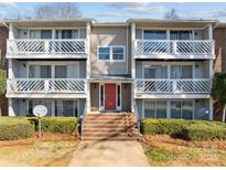 Attractive condo building with a red front door and private balconies perfect for relaxing outdoors at 9405 Old Concord Rd # G, Charlotte, NC 28213