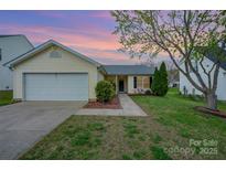 Charming one-story home with attached garage, tidy lawn and mature tree in established neighborhood at 10130 Illoria Dr, Charlotte, NC 28273