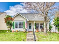 Charming home featuring a well-manicured front yard and inviting porch with a decorative wreath and rocking chairs at 1505 Andora Dr, Rock Hill, SC 29732
