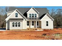 Charming craftsman-style home featuring board and batten siding, a covered porch, and a gabled roofline at 215 Triple Ponds Ct, Clover, SC 29710