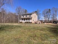 Charming two-story home featuring a welcoming front porch and a spacious yard, perfect for outdoor activities at 3032 Morning Glory Ln, Vale, NC 28168