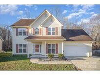 Charming two-story home with red shutters, well-manicured lawn, and inviting front porch at 341 Long Creek Pkwy, Charlotte, NC 28214