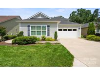 Charming single-story home with a well-manicured lawn, gray siding, and a two-car garage at 4922 Looking Glass Trl, Denver, NC 28037