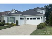 Home with a two-car garage and well-manicured landscaping, driveway, and charming architectural details at 4922 Looking Glass Trl, Denver, NC 28037