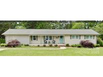 Charming single-story home with a welcoming front porch and well-manicured lawn and a pale blue door at 666 Morningside Dr # 13, Rock Hill, SC 29730