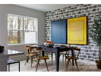Bright dining room with modern decor, featuring a stylish table and chairs near a window at 7004 Matz Way, Charlotte, NC 28269