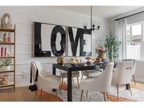 Modern dining room featuring stylish chandelier, art and seating with elegant rug at 7008 Matz Way, Charlotte, NC 28269