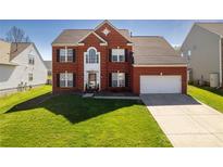Beautiful two-story red brick home with a well-manicured lawn, attached garage, and inviting curb appeal at 10146 Spring Park Dr, Charlotte, NC 28269