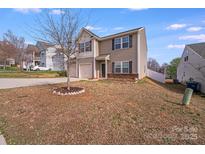 Charming two-story home with a two-car garage and neatly maintained front yard in a desirable neighborhood at 105 Abel Peterson Dr, Mount Holly, NC 28120