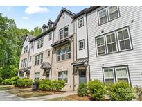 Attractive townhome exteriors with brick and siding, featuring well-maintained landscaping at 12312 Landry Renee Pl # 35, Charlotte, NC 28277