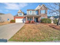 Charming two-story home with a two-car garage and a well-maintained lawn at 12724 Hunting Birds Ln, Charlotte, NC 28278