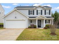 Charming two-story home with a two car garage, well-kept lawn and inviting front porch at 13108 Rothe House Rd # 167, Charlotte, NC 28273
