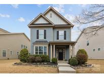 Charming two-story home boasts manicured landscaping and classic architectural details at 1710 Woodward Ave, Charlotte, NC 28206