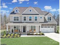 Charming two-story home with a welcoming front porch and well-manicured lawn and a two car garage at 17111 Monocacy Blvd, Huntersville, NC 28078