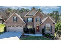 Charming brick home with a well-manicured lawn, arched doorway, and a two-car garage at 3815 10Th Ne St, Hickory, NC 28601