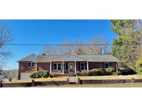 Charming brick home with a welcoming front porch and well-maintained landscaping at 408 E Ryder Ave, Landis, NC 28088