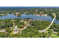 Beautiful aerial view of lakefront home with pool and wooded surroundings at 4808 1St Nw St, Hickory, NC 28601