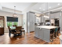 Charming dining area with modern chandelier, wooden table and lots of natural light at 4808 1St Nw St, Hickory, NC 28601