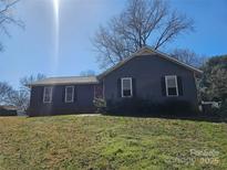 Charming single-story home with gray siding, black shutters, and a red front door at 5815 Katrine Ct, Charlotte, NC 28208