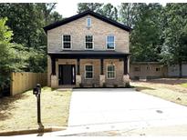 Charming two-story brick home featuring a covered porch and a spacious concrete driveway at 588 Washington Ln, Albemarle, NC 28001