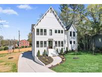 Stunning two-story home with a long driveway and well-maintained lawn and landscaping at 621 Poindexter Dr, Charlotte, NC 28209