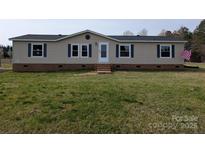 Charming single-story home with light-colored siding, blue shutters, and a well-maintained lawn at 7051 Maple Glen Dr, Catawba, NC 28609