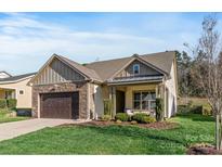 Charming single-Gathering home featuring stone accents, a two-car garage, and a well-maintained lawn at 7127 Hanging Rock Ct, Denver, NC 28037