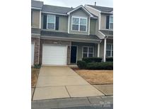 Charming two-story townhouse with a one car garage and well-maintained front lawn at 7141 Adare Mews Rd, Charlotte, NC 28217