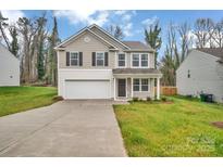 Charming two-story home featuring a well-maintained lawn and an attached two car garage at 7623 E Lane Dr, Charlotte, NC 28212