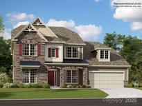 Charming two-story home featuring a stone facade, complemented by red shutters and a well-manicured lawn at 1609 Croydon St, Indian Land, SC 29707