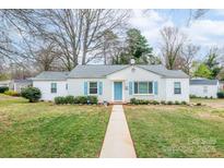 Charming single story home with walkway, blue shutters, neutral paint and lush front yard at 3036 Marlowe Ave, Charlotte, NC 28208