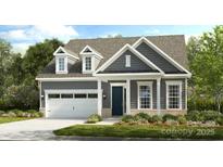 Charming new construction featuring a two-car garage, neutral-colored exterior, and well-maintained landscaping at 333 Basil Dr, Indian Trail, NC 28079
