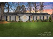 Charming single-story home boasting a freshly cut lawn, shutters, and inviting front porch at 3830 Lovett Cir, Charlotte, NC 28210