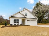 Charming new construction with white siding, well-manicured lawn, and a two-car garage at 5609 Morgan Mill Rd, Monroe, NC 28110