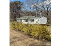 Charming one-story home with blooming bushes and a well-maintained lawn, offering great curb appeal at 5949 Flat Creek Rd, Kershaw, SC 29067