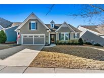Charming single-story home featuring a well-manicured lawn and an attached two-car garage at 7118 Overjoyed Xing, Charlotte, NC 28215