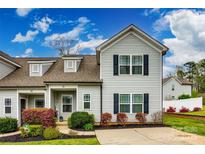 Charming two-story home with a well-manicured lawn, beautiful landscaping, and a private driveway at 730 Shuttles Way, Fort Mill, SC 29715